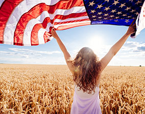 A person waving an American flag hoping to share Biblical truth with our nation 